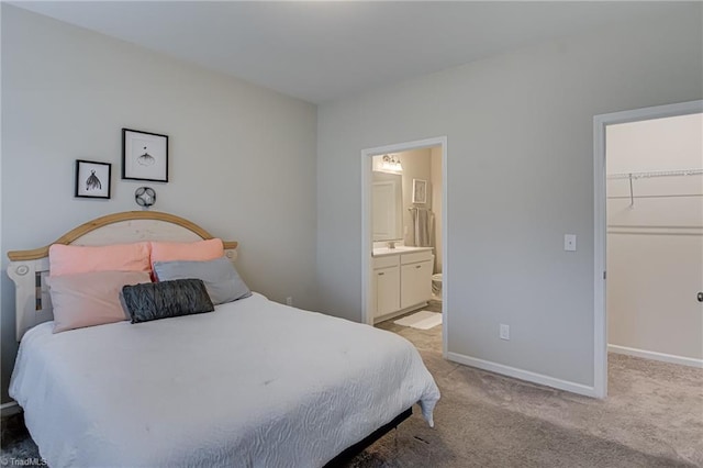 1438 Crestlawn Trl, Pfafftown, NC 27040 - bedroom featuring a walk in closet, light colored carpet, baseboards, ensuite bathroom, and a closet