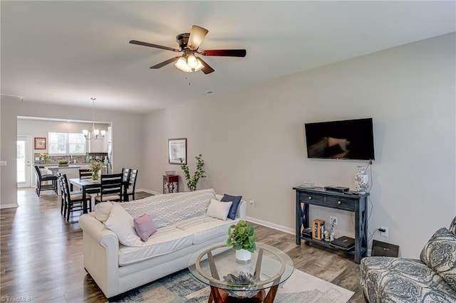 1438 Crestlawn Trl, Pfafftown, NC 27040 - living room featuring a chandelier, wood finished floors, a ceiling fan, and baseboards