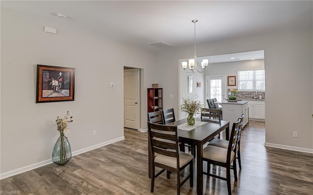 1438 Crestlawn Trl, Pfafftown, NC 27040 - dining space with a chandelier, dark wood-style floors, and baseboards