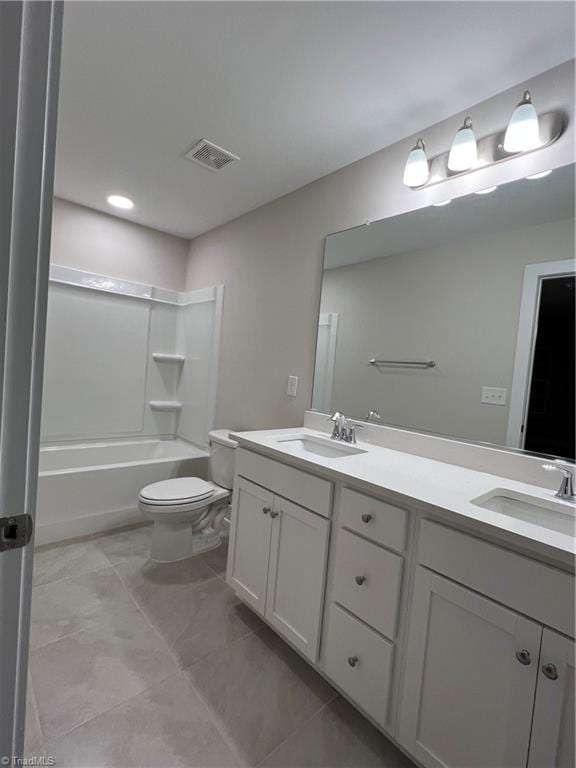 bathroom with double vanity, visible vents, toilet, and a sink