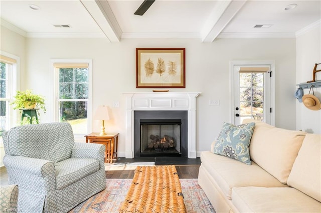 living room with beamed ceiling, crown molding, and wood-type flooring