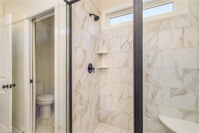 bathroom with an enclosed shower and toilet