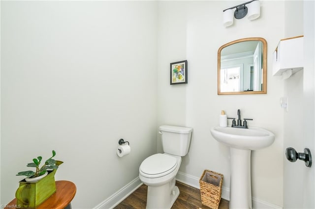 bathroom with sink, toilet, and hardwood / wood-style floors