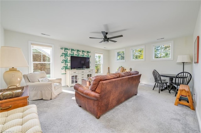 living room featuring light colored carpet and ceiling fan