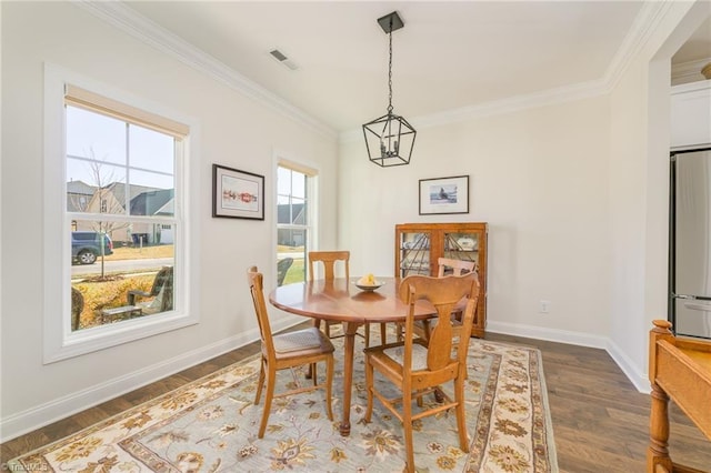 dining space with crown molding and dark hardwood / wood-style flooring