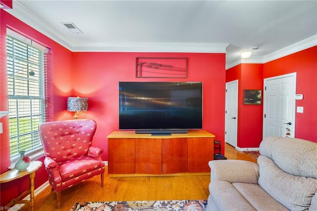 living room featuring crown molding and wood finished floors
