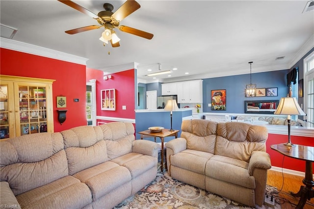 living room with crown molding, recessed lighting, and ceiling fan