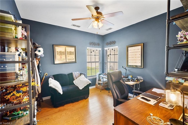 home office with a ceiling fan, wood finished floors, and baseboards