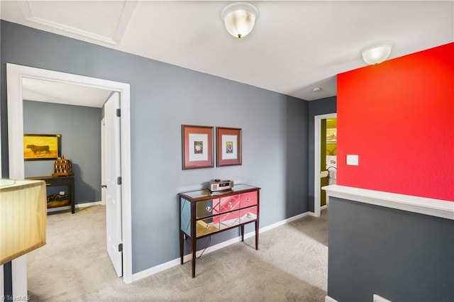 hallway with carpet and baseboards