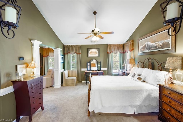 carpeted bedroom with lofted ceiling, ornate columns, a ceiling fan, and baseboards