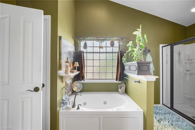 full bathroom featuring a shower stall and a whirlpool tub