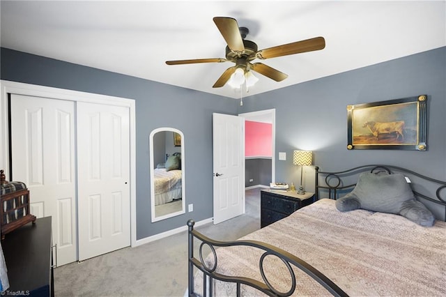 bedroom featuring carpet floors, a closet, baseboards, and a ceiling fan