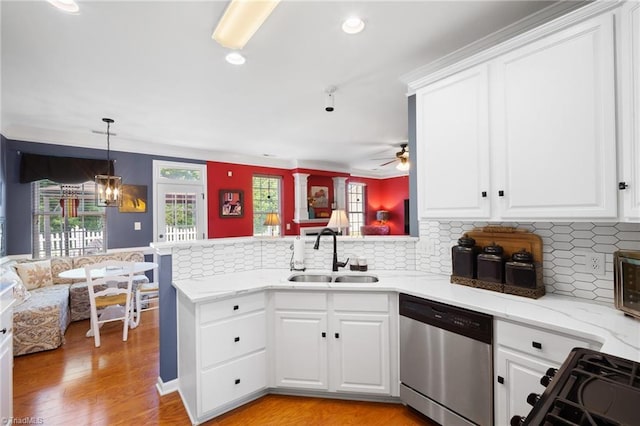 kitchen featuring dishwasher, a sink, a peninsula, black range with gas stovetop, and white cabinetry