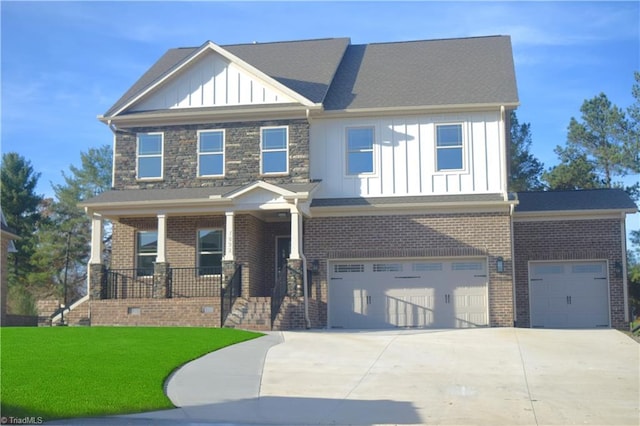 craftsman-style home featuring board and batten siding, a garage, a porch, a front yard, and driveway