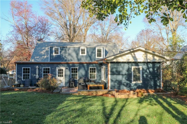 rear view of house featuring a patio and a yard