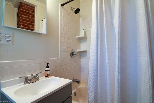 full bath with shower / tub combo with curtain, tile walls, and vanity