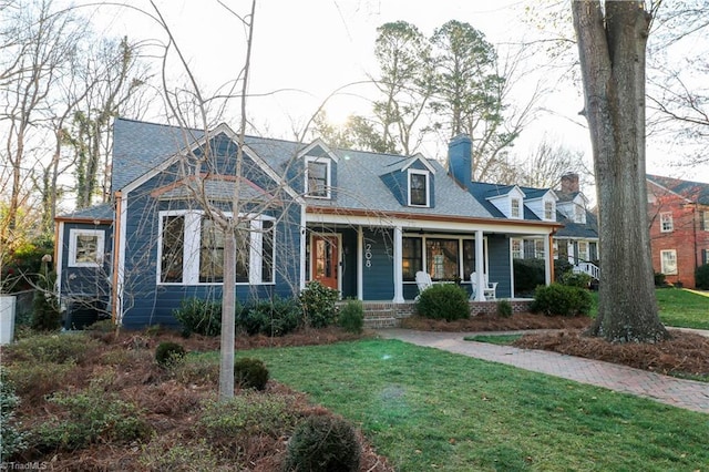 cape cod house with a front yard, covered porch, and a chimney