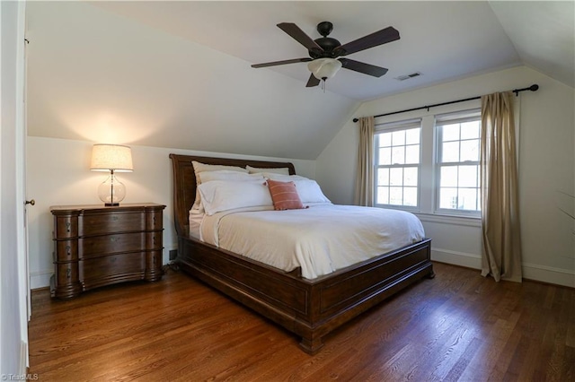 bedroom featuring visible vents, ceiling fan, baseboards, vaulted ceiling, and wood finished floors