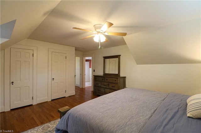 bedroom with a ceiling fan, vaulted ceiling, and wood finished floors