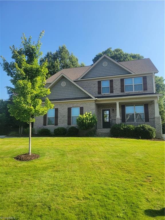 1320 Trafalgar Dr, High Point, NC 27262 - craftsman inspired home featuring a front lawn, covered porch, and brick siding