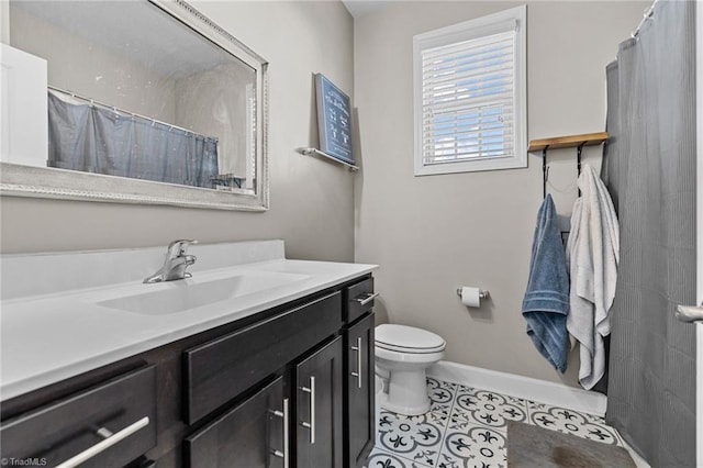 bathroom featuring toilet, tile patterned floors, and vanity