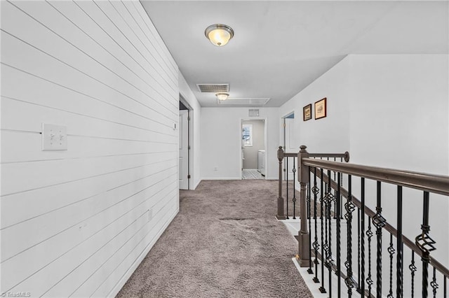 hall featuring washer / dryer and carpet