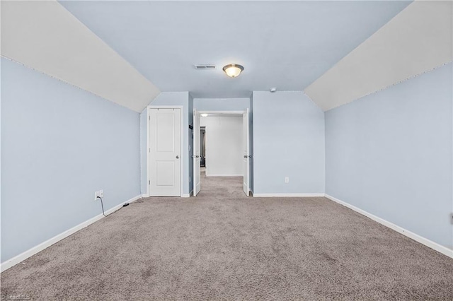 bonus room with lofted ceiling and carpet flooring