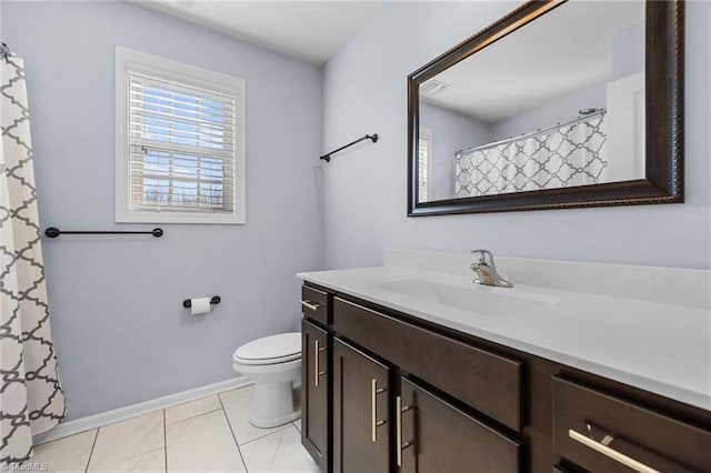 bathroom with toilet, tile patterned flooring, and vanity