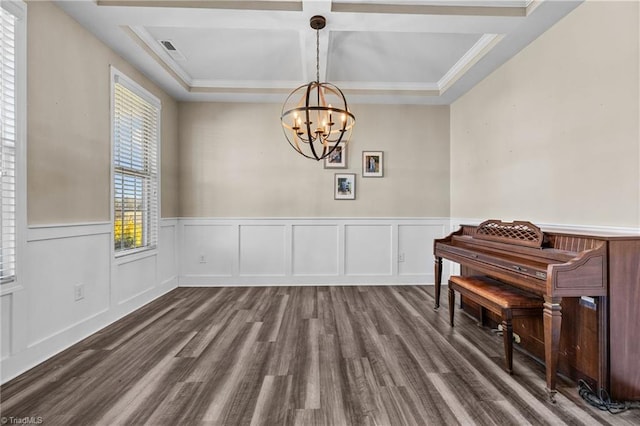 interior space featuring an inviting chandelier, hardwood / wood-style floors, coffered ceiling, crown molding, and beam ceiling