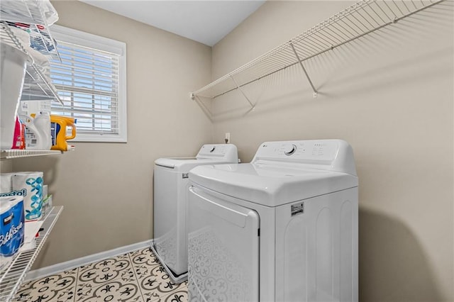 clothes washing area with separate washer and dryer