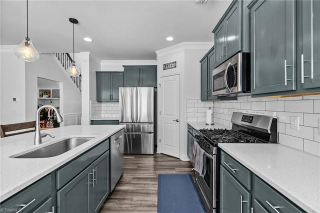 kitchen with stainless steel appliances, crown molding, decorative light fixtures, and sink