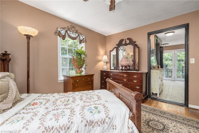 238 Maple St, King, NC 27021 - bedroom with wood finished floors, multiple windows, and a ceiling fan