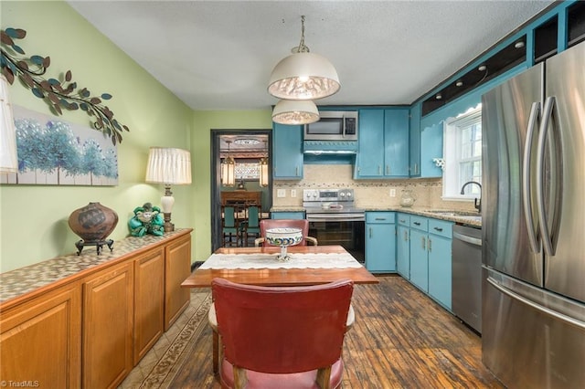 238 Maple St, King, NC 27021 - kitchen featuring stainless steel appliances, a sink, blue cabinets, light countertops, and dark wood-style floors