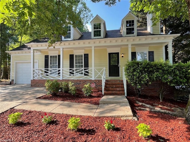 2 Whispering Ct, Greensboro, NC 27407 - view of front facade featuring covered porch, a garage, concrete driveway, and a chimney