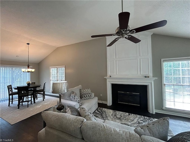 2 Whispering Ct, Greensboro, NC 27407 - living room featuring vaulted ceiling, dark wood-style flooring, a chandelier, ceiling fan, and a fireplace