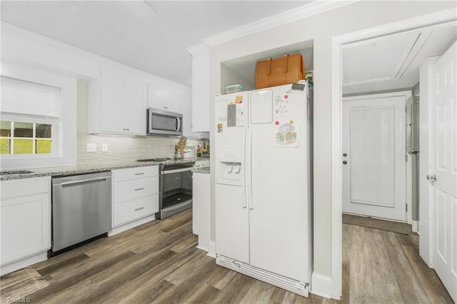 4814 Merrimac St, Winston-Salem, NC 27105 - kitchen with appliances with stainless steel finishes, dark wood-style flooring, white cabinets, tasteful backsplash, and crown molding