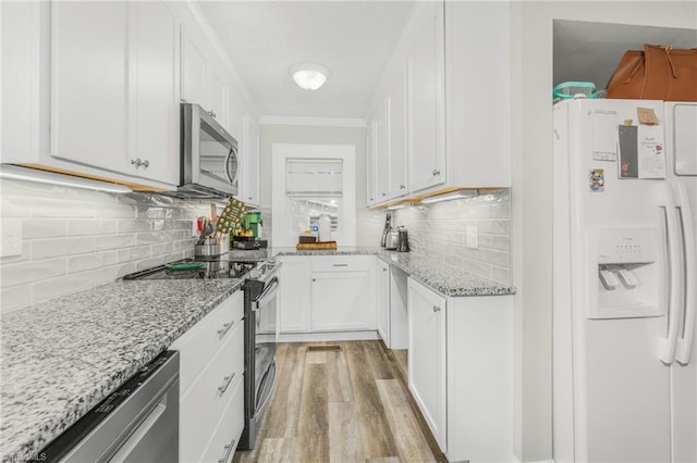 4814 Merrimac St, Winston-Salem, NC 27105 - kitchen featuring stainless steel appliances, light wood-style floors, white cabinets, light stone countertops, and ornamental molding