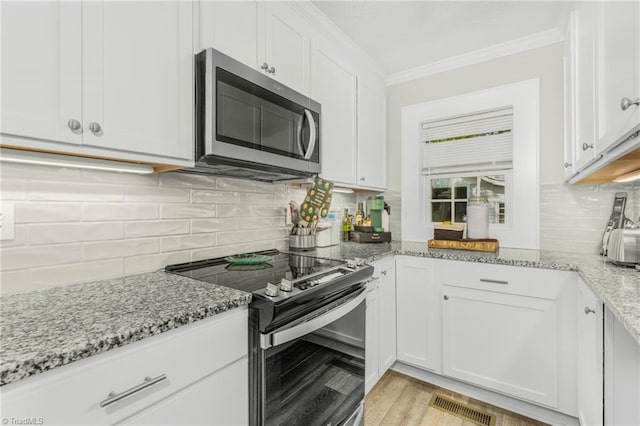 4814 Merrimac St, Winston-Salem, NC 27105 - kitchen with stainless steel appliances, crown molding, white cabinets, and tasteful backsplash