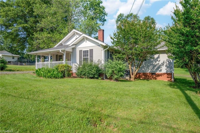4814 Merrimac St, Winston-Salem, NC 27105 - view of front of home with a chimney, covered porch, and a front yard