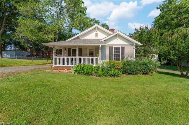 4814 Merrimac St, Winston-Salem, NC 27105 - bungalow-style house with a porch, a front yard, driveway, and a chimney