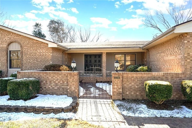 view of snow covered property entrance