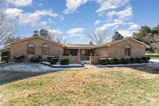 ranch-style home with a front lawn