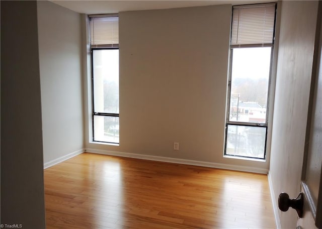 unfurnished room with light hardwood / wood-style floors