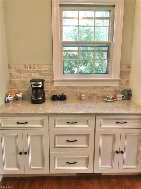 interior details with hardwood / wood-style flooring and backsplash