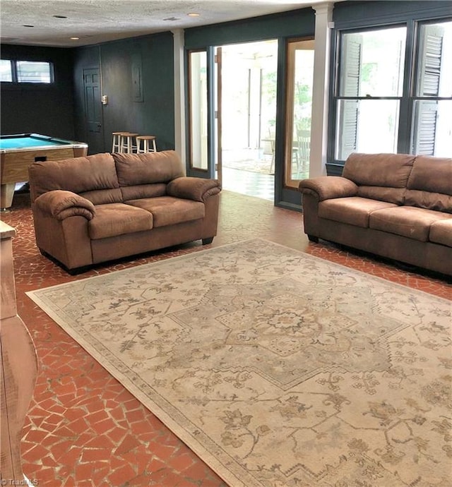 living room featuring a textured ceiling and pool table