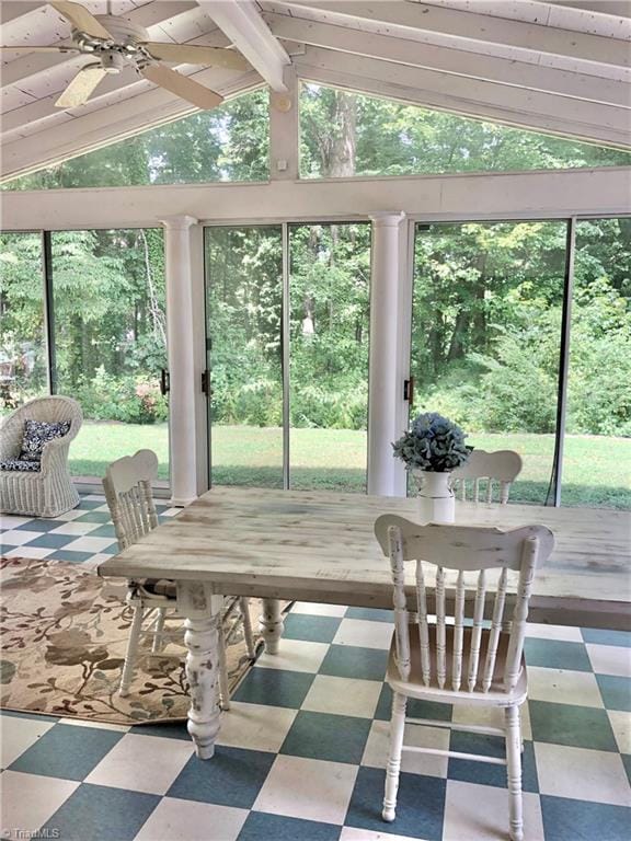 sunroom with vaulted ceiling with beams, ceiling fan, and plenty of natural light