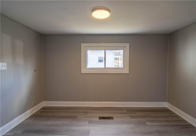 spare room with hardwood / wood-style flooring and ornamental molding