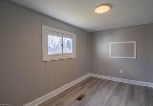 empty room with hardwood / wood-style floors