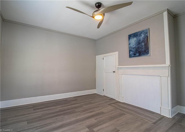 spare room with ceiling fan, crown molding, and hardwood / wood-style flooring