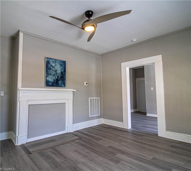 unfurnished living room with ceiling fan, dark hardwood / wood-style floors, and crown molding